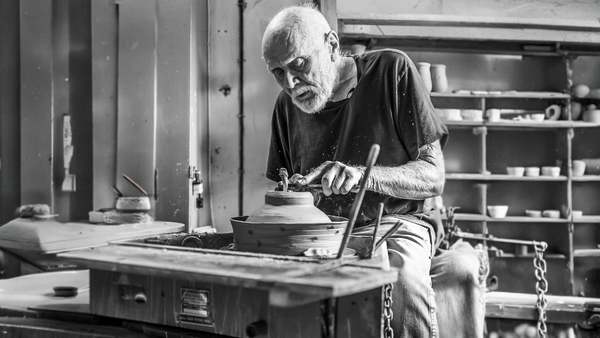 Warren Mackenzie throwing a bowl on his kick wheel in his Stillwater Minnesota Studio
